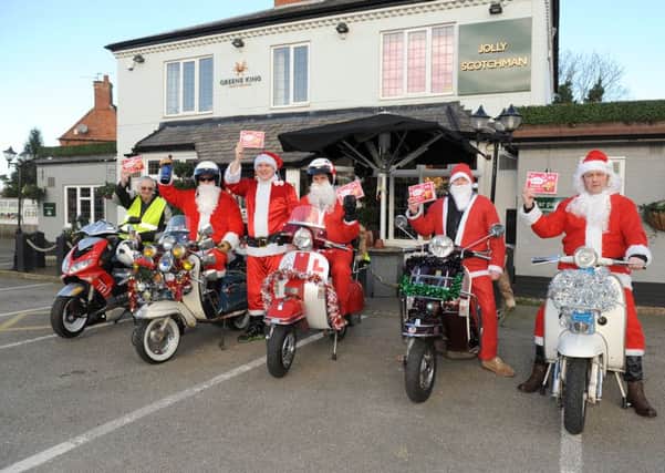 Sleaford All Knighters Scooter Club members setting off from the Jolly Scotchman to deliver mince pies and sherry donated by the pub, to Roxholm Nursing Home. From left - Roy Workman, Rob Castle, Michael Norbury - Jolly Scotchman general manager, Graham Foster, Andy Priestley and Paul Franks. EMN-151221-134349001