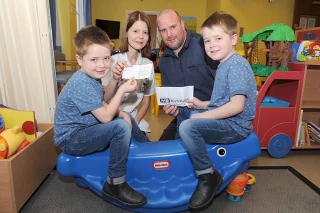 Julia Thompson and family with Mick Small, handing over £500 to Pilgrim Hospital's Children's Ward. L-R Regan Skinner 6, Chantelle Harris - staff nurse, Mick Small, Logan Skinner 6.