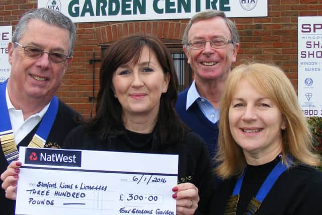Presenting ?300 raised from donations at the Santa's Grotto, Four Seasons Garden Centre director Nicola Woods, centre, with, from left - Bob Coxhead - Sleaford Lions president, John Kyte - Lions' sleigh organiser and Tracy Arnold - Sleaford Lionesses president. EMN-160601-153112001
