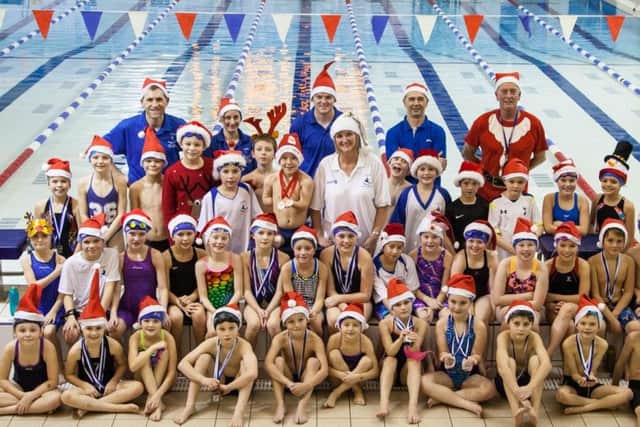 Harvey (centre of second row from back) is pictured next to his coach Sarah Richardson at Louth Swimming Clubs Santa Sprints Gala with his fellow Skills Squad Swimmers and coaches EMN-160701-170359002