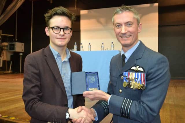 Joshua Kilcullen receives his 'Exceptional Performance' GCSE award from Wing Commander  Paul Moss.
