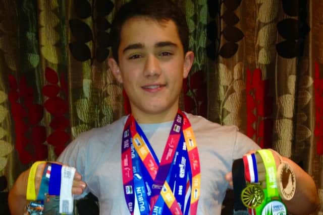 MARATHON MAN: William Chico of Caister Grammar School with his haul of medals after a year of marathons, half-marathons, duathlons and triathlons.