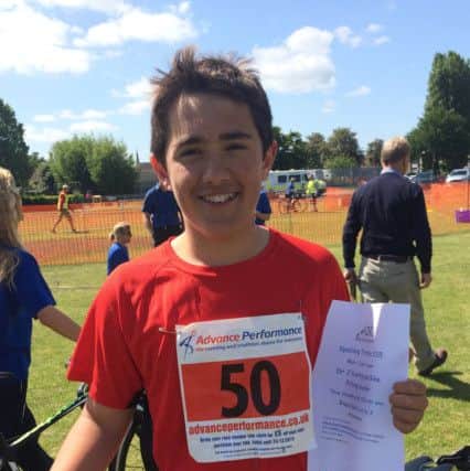 FIRST WIN: William Chico proudly holds his certificate as under-20 category winner at the Spalding Sprint Triathlon in June 2015.