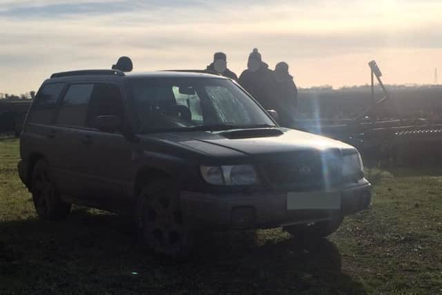 A group of males spoken to by police over their vehicle during the Op Galileo.