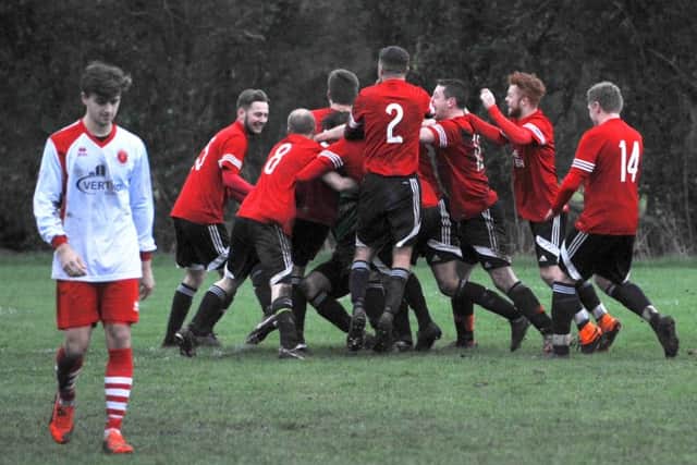 McCauley Parker leaves the pitch as Epworth celebrate the penalty save.