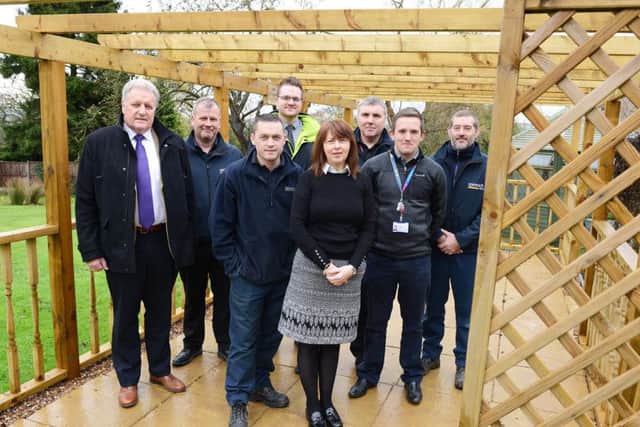 Tina Dingley is pictured with volunteers from BT Outreach and Turnbull & Co Sleaford under the new pergola.