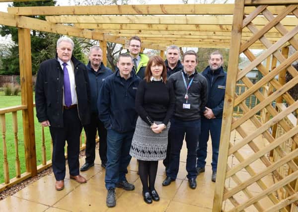 Tina Dingley is pictured with volunteers from BT Outreach and Turnbull & Co Sleaford under the new pergola.