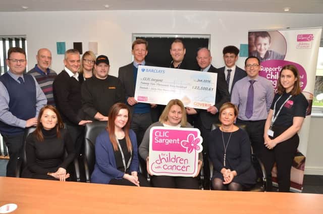 Coveris employees with a magnificent cheque for CLIC Sargent.