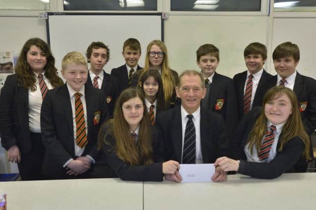 David Vasey from Kettles Funeral Directors with the Cordeaux Young Carers group .