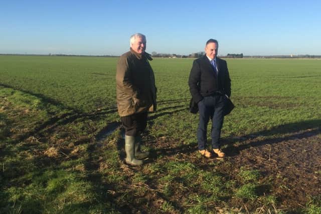 Leonard Morris (left) and Stephen Phillips (right) inspecting damage to crops from cars used by hare coursers. EMN-160121-122148001