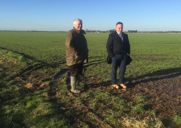 Leonard Morris (left) and Stephen Phillips (right) inspecting damage to crops from cars used by hare coursers. EMN-160121-122148001