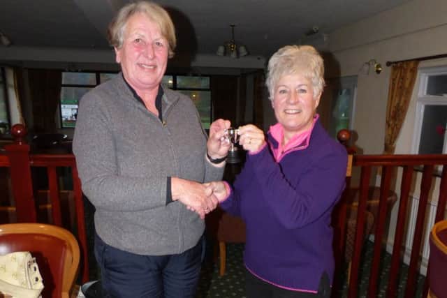 Margaret Dixon (left) receives her prize from Market Rasen GC lady captain Helen Grinham EMN-160121-160411002