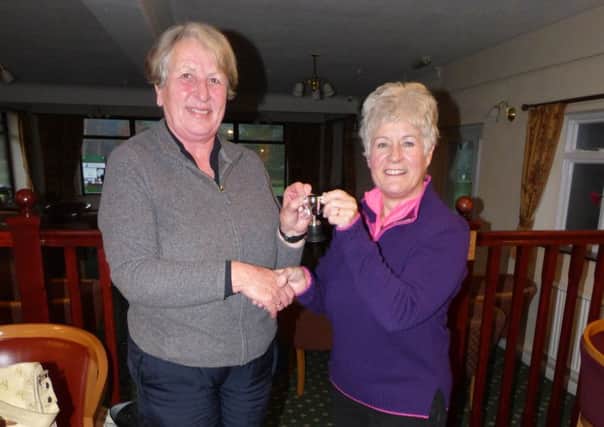 Margaret Dixon (left) receives her prize from Market Rasen GC lady captain Helen Grinham EMN-160121-160411002