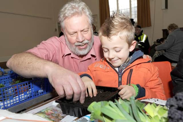 Boston Town Team's first event, Local Food For Thought. Arthur Davey of Willoughby Road Allotments, helping Jacob Wilder 6 sow seeds.