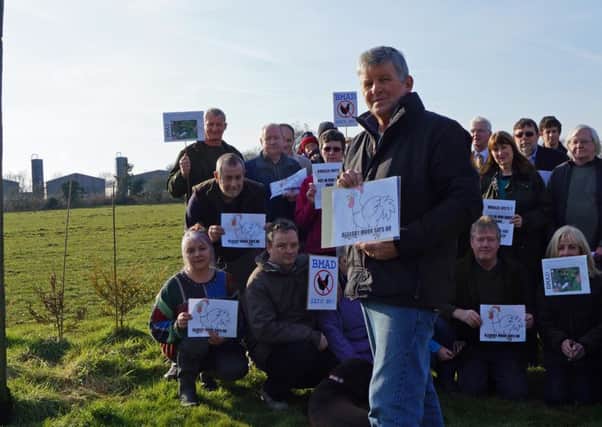 Bleasby Moor residents action group with the units in the background EMN-160126-124503001