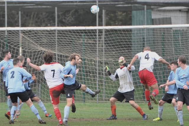 Goalmouth action during the game between Horncastle Town (blue shirts) and Market Rasen Town. Photo: Nigel West
