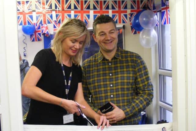 BBC Radio Lincolnshire presenters Scott Dalton and Carla George cut the ribbon at Metheringham library. EMN-160125-130122001