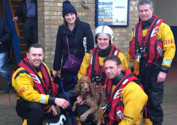 Claire Hallam with Skegness RNLI volunteers with family pet Bonnie who they helped after running into the sea. ANL-160129-145843001