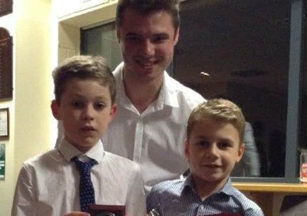 Mini Red runner-up Connor Buckley and winner Matthew Key with coach Morgan Vickers EMN-160128-123509002