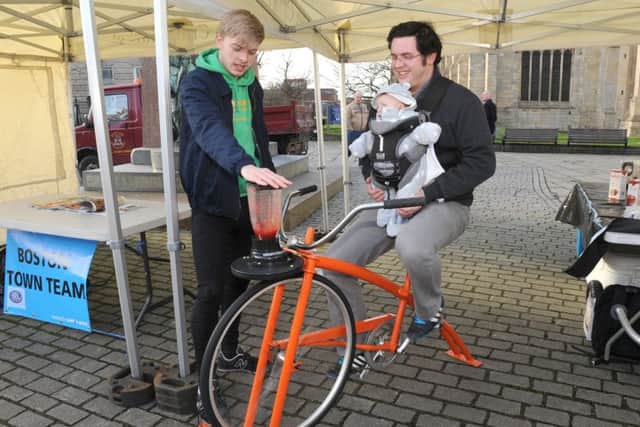 Boston Town Team's first event, Local Food For Thought. Dan Elkington with Arthur Elkington of Boston making a smoothie on a smoothie bike, helped by Smoothie Bike Instructor Orrin Shakeshaft.