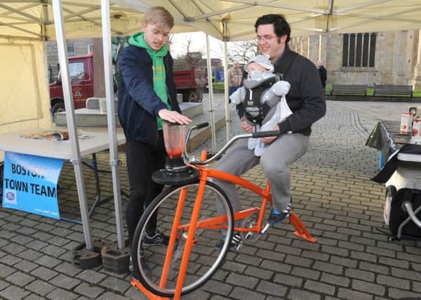 Boston Town Team's first event, Local Food For Thought. Dan Elkington with Arthur Elkington of Boston making a smoothie on a smoothie bike, helped by Smoothie Bike Instructor Orrin Shakeshaft.