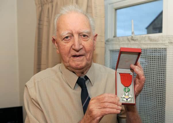 92 year old Normandy Veteran Eric Ingham, pictured with his medal.