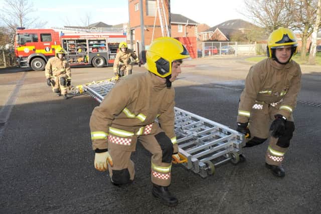 Skegness Fire Station open day. Ladder Lift Back L-R Firefighter Daniel Gowling, Firefighter Samuel Hayward. Front L-R Connell McGrorey of Skegness, Firefighter Davey Downes.