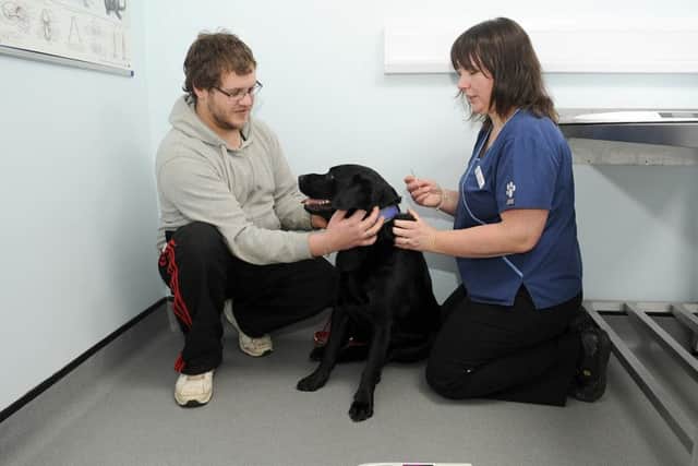 Micro chipping at Quarrington Vets. L-R Stephen Wright of Sleaford with his dog Sam 4, being micro chipped by Veternary Surgeon Jillian Kerr. EMN-160102-115604001
