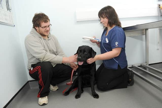Micro chipping at Quarrington Vets. L-R Stephen Wright of Sleaford with his dog Sam 4, being micro chipped by Veternary Surgeon Jillian Kerr. EMN-160102-115615001