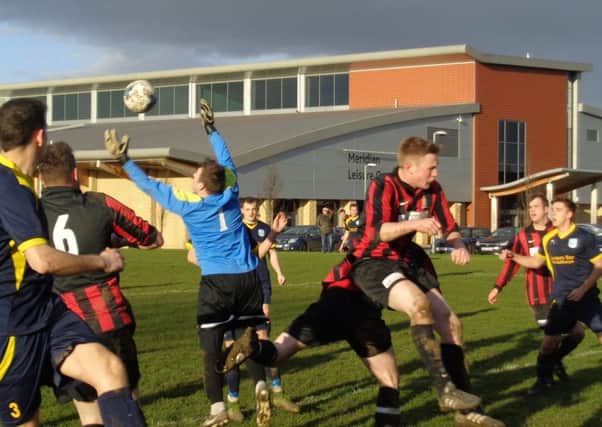 Danny Stevens jumps to catch the ball for Mablethorpe in their league derby clash with AFC Louth EMN-160102-103355002