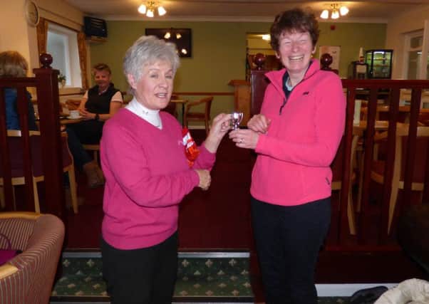 Winner Joy Purkiss (right) receives her trophy from lady captain Helen Grinham EMN-160102-154703002