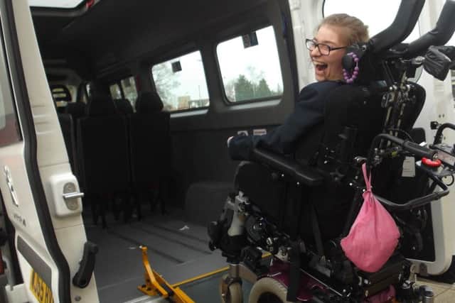 St George's Academy student Milly tests out the tail lift on one of the new minibuses. EMN-160402-150617001
