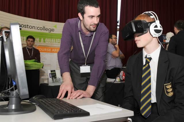 Chambers Career Fair at Boston Grammar School. L-R Computing lecturer at Boston College Gary Chapman-Jones with Joshua Hooper 15, trying a virtural reality head set.