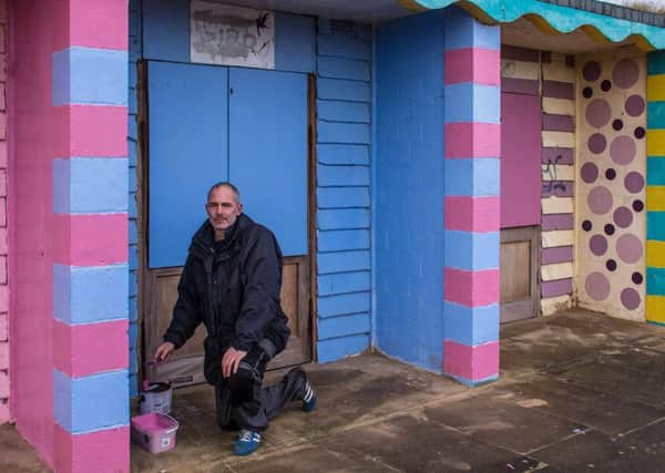 Bobby Baldwin has been busy repainting the beach chalets targeted with graffiti. Inset: Just one of the four chalets that were vandalised.