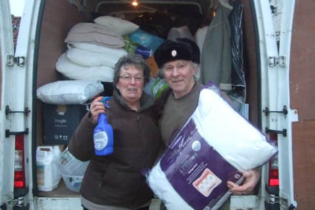 Tina McNeil and 7th Boston Scouts' leader Alan Blackhorse-Hull with items collected from the Suttons to help Yorkshire flood victims. ANL-160902-123129001