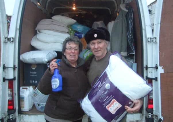 Tina McNeil and 7th Boston Scouts' leader Alan Blackhorse-Hull with items collected from the Suttons to help Yorkshire flood victims. ANL-160902-123129001