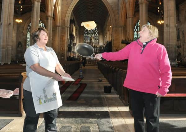 Boston Stump opens to the public for the first time since the floods, giving free pancakes to visitors. L-R Domestic manager Polly Tamberlin and Rev Alyson Buxton making pancakes.
