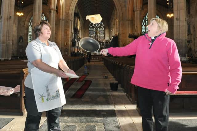 Boston Stump opens to the public for the first time since the floods, giving free pancakes to visitors. L-R Domestic manager Polly Tamberlin and Rev Alyson Buxton making pancakes.