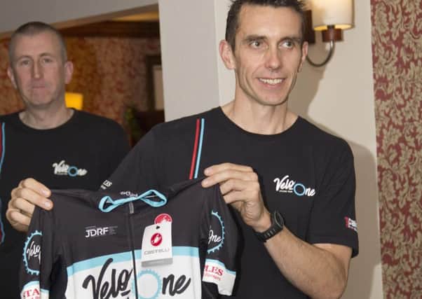 Velo-One rider Adam Ellis reveals the team jersey at their launch night. Photo: @ChrisGaleyPhoto