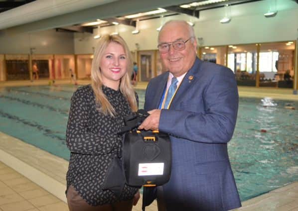 Rotary Club president John Elkington presents a defibrillator to Sleaford Leisure Centre EMN-160216-133252001