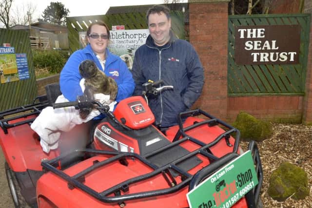 Co-owner Chloe Drew pictured with six-week old male seal Toothless, who was recently rescued, and Sam Plowright from The Tractor Shop in Louth.