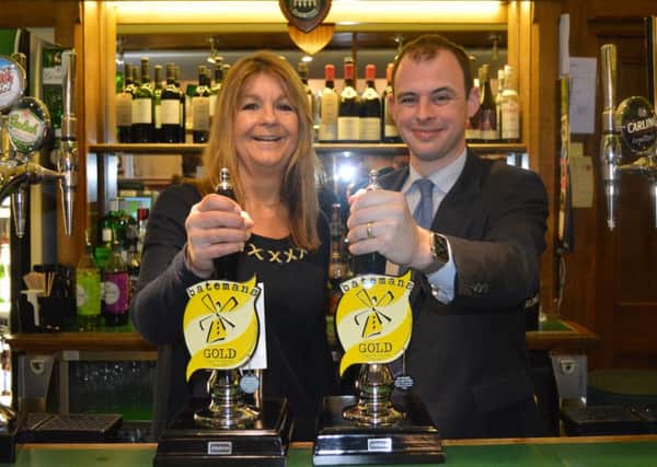 Matt Warman MP with Jaclyn Bateman, marketing director of Batemans Brewery in Parliament's Stranger's Bar ANL-160216-142304001