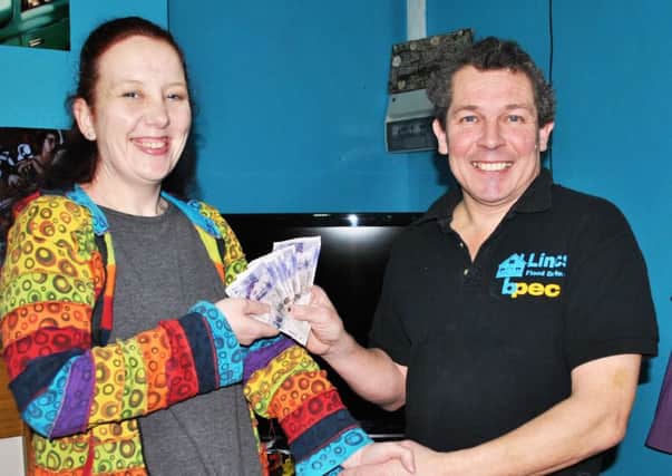Amanda receives her Â£100 prize from Mark.