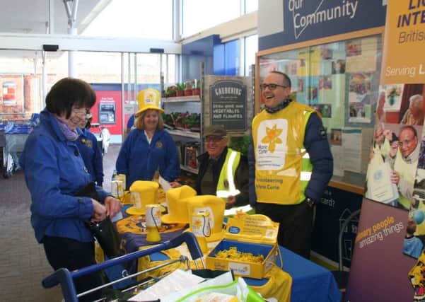 Shopper Elaine Parkinson shares a joke with Market Rasen Lions as they collect for Marie Curie Cancer Care EMN-160225-061715001