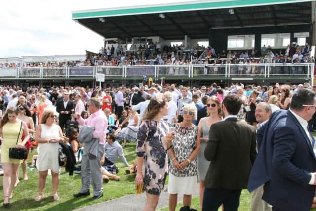 The huge sell out crowd for Journal Ladies Day at Market Rasen bask in the sunshine EMN-160223-134302001