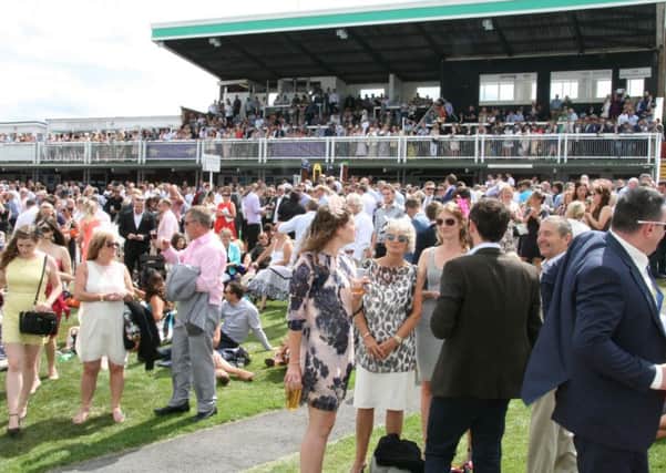 The huge sell out crowd for Journal Ladies Day at Market Rasen bask in the sunshine EMN-160223-134302001