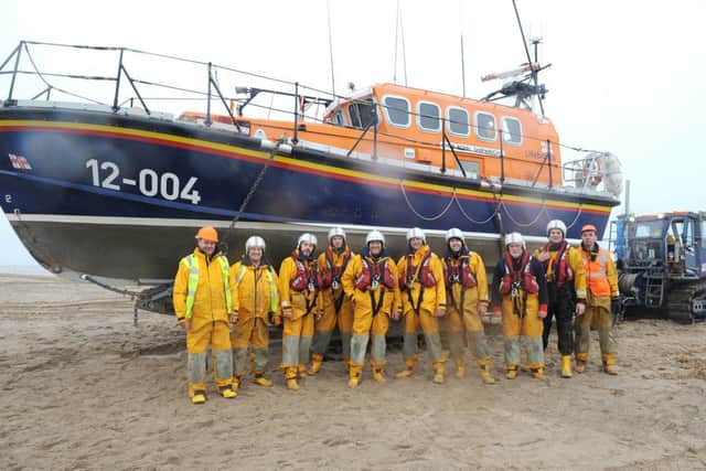 Skegness Lifeboat crew returning to Skegness Central Beach after a practice. ANL-160802-123757001