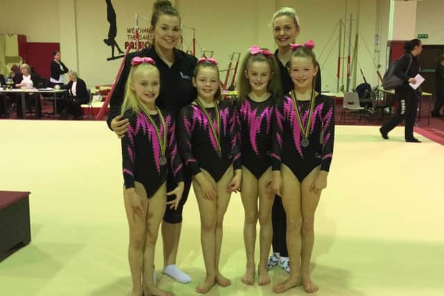 Pictured are Amelia, Tallulah, Eden and Lyle (front left to right) and their coaches Kim Glasel and Kim Hughes.