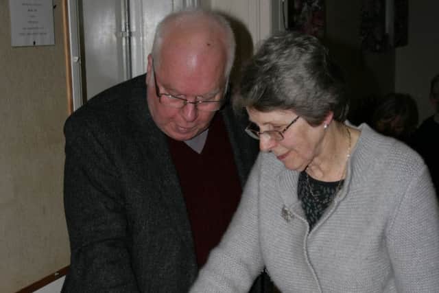 Bob and Susan Emm cutting their retirement cake.