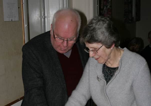 Bob and Susan Emm cutting their retirement cake.